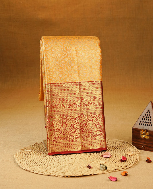 Mustard yellow Colour Semi Tissue Silk Saree featuring Floral Kodi Gold Zari Work on the body, complemented by an intricately woven gold zari pallu, a rich Maroon and gold zari border, and paired with a matching plain blouse piece