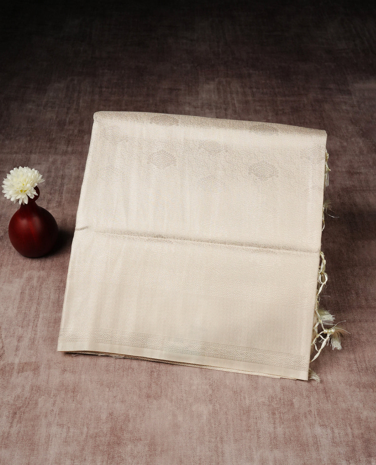 Off white colour softie silk saree featuring silvar zari, rich pallu floral pattern brocade body, with contrasting self colour border.paired with matching blouse piece.