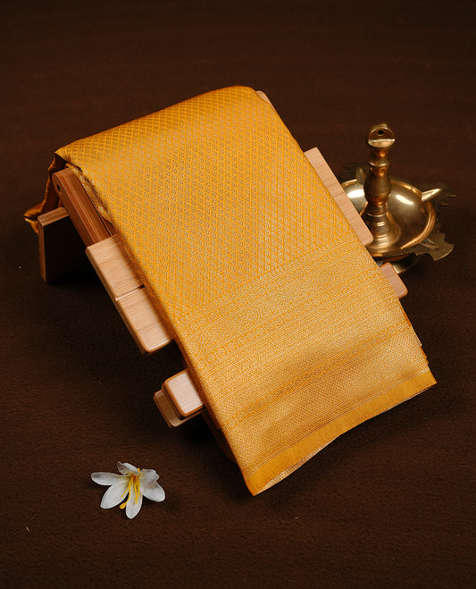 Yellow colour soft silk saree featuring gold zari pattern on body, complemented by self colour with traditional border, paired with matching blouse piece.