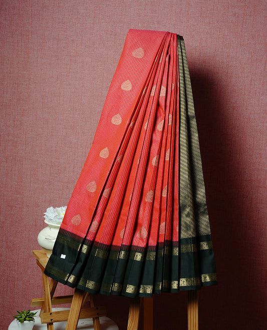 Red coloured soft silk saree featuring gold zari stripes and motifs across the body, enhanced with a contrast Dark greenborder and pallu, paired with a matching contrast blouse piece.