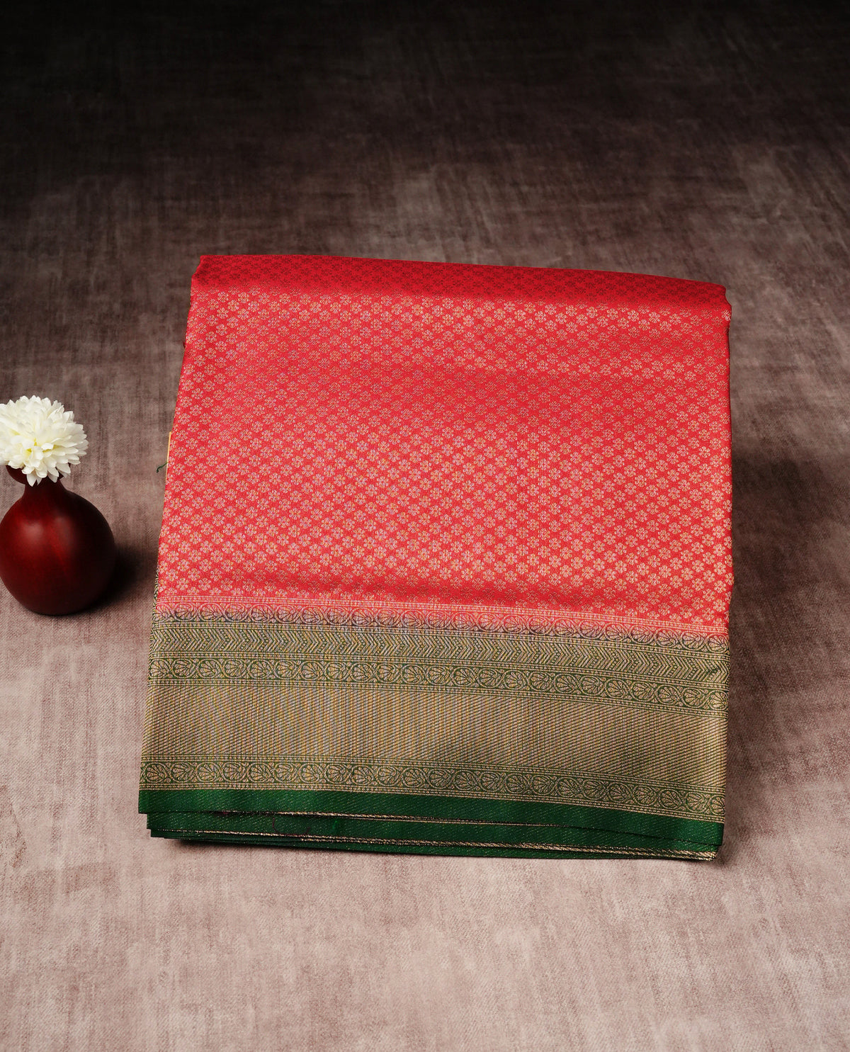 Red colour softie silk saree featuring gold zari, rich pallu floral pattern brocade body, with contrasting green colour border.paired with matching blouse piece.