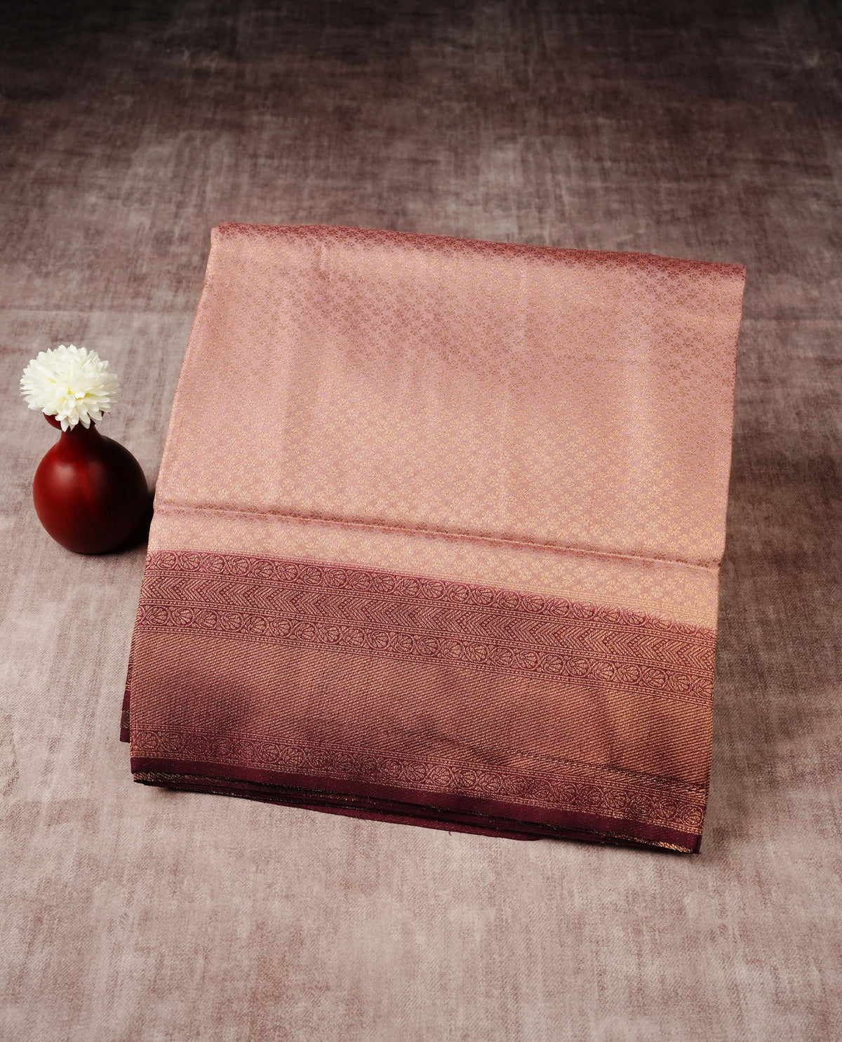 Muted brown colour softie silk saree featuring gold zari, rich pallu floral pattern brocade body, with contrasting chocolate colour border.paired with matching blouse piece.