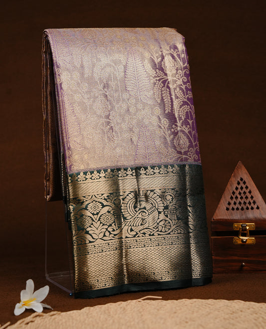 Purple & gold double shade colour semi tissue silk saree featuring gold zari floral kodi pattern on body, contrast green colour with gold zari traditional border, paired with matching blouse piece.
