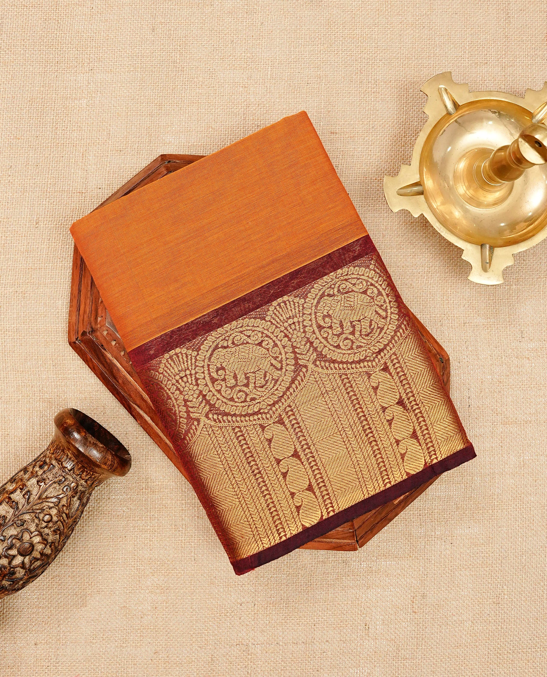 Rust orange colour chettinad cotton saree featuring elegant plain body, Contrast maroon colour with Gold zari border, comes with matching blouse piece.