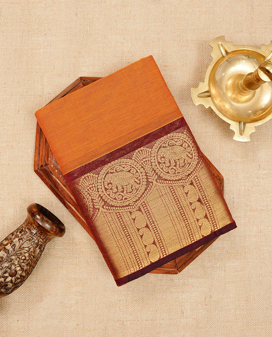 Rust orange colour chettinad cotton saree featuring elegant plain body, Contrast maroon colour with Gold zari border, comes with matching blouse piece.