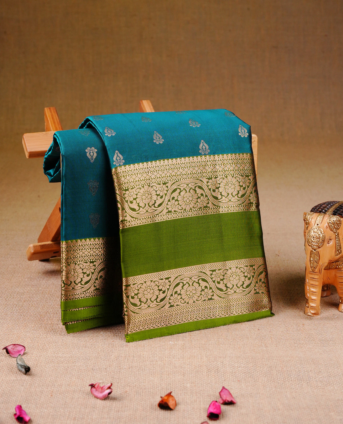 Teal Blue colour Traditional Kancheepuram Silk Saree with Elegant Gold Zari Buttas on the Body, Enhanced with a Contrast Green Colour  with Gold Zari Border and Rich Pallu, Paired with a Matching Blouse Piece.