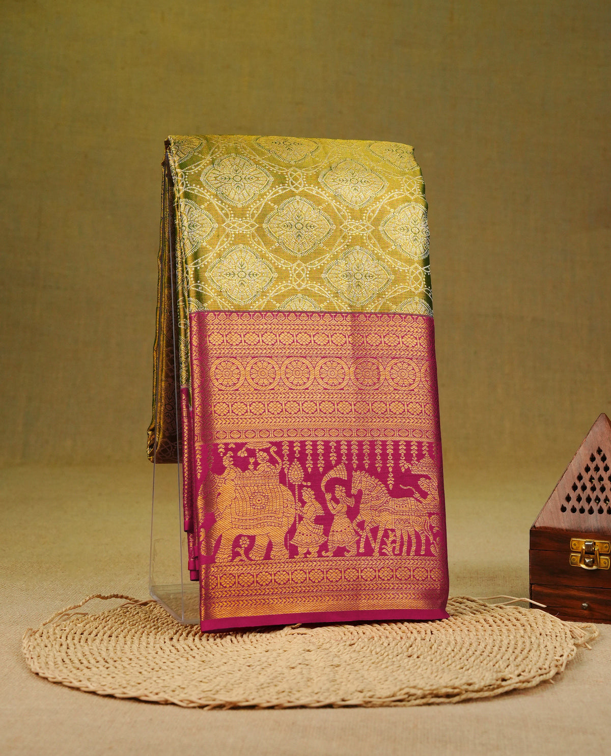 Mehandi Green colour pure tissue silk saree featuring Gold zari floral pattern on body, complemented by Dark magenta colour traditional border, comes with matching blouse piece.