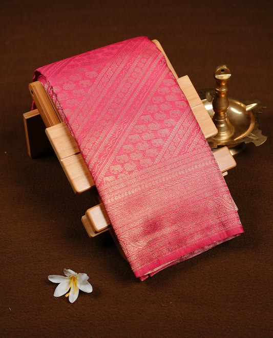 Magenta colour soft silk saree featuring gold zari pattern on body, complemented by self colour with traditional border, paired with matching blouse piece.