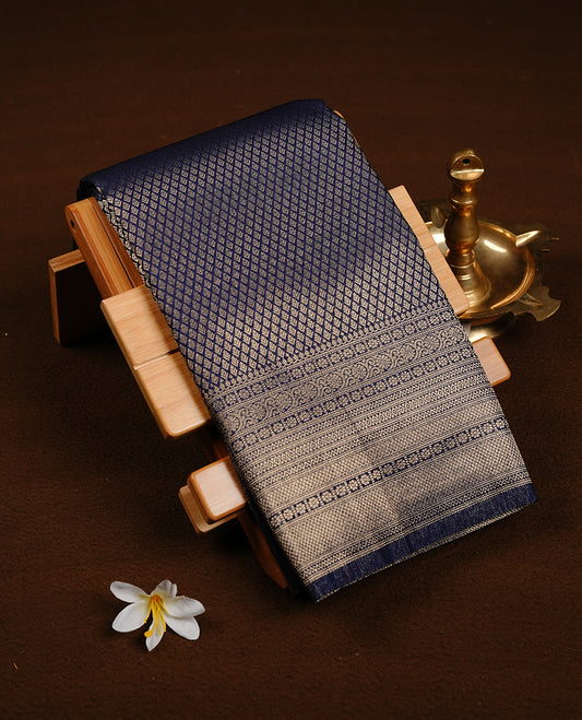 Navy Blue colour soft silk saree featuring gold zari pattern on body, complemented by self colour with traditional border, paired with matching blouse piece.