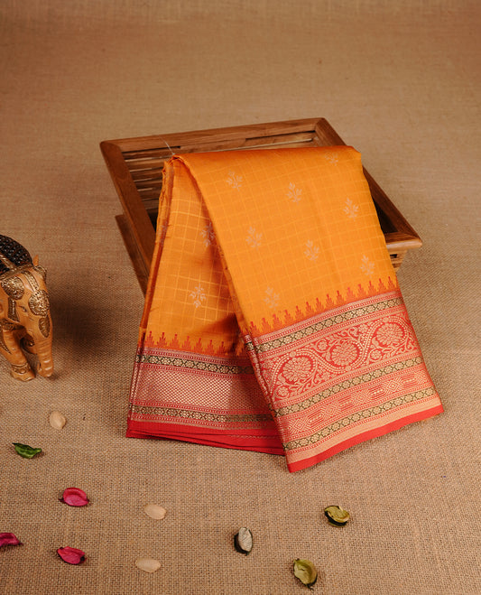 Mustard colour traditional kancheepuram silk saree featuring gold zari check pattern on body, complemented by contrast red colour with gold zari traditional border, paired with matching blouse piece.