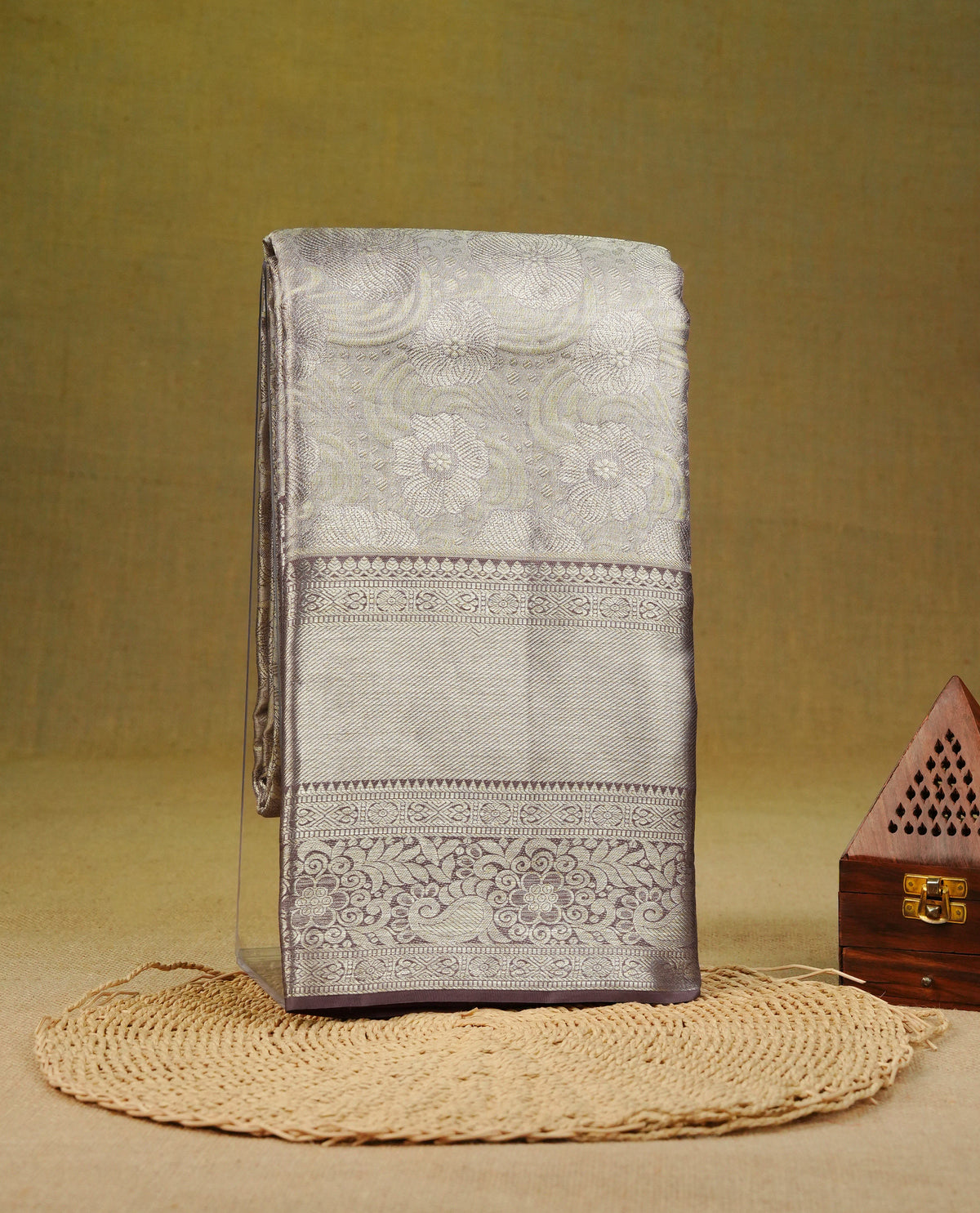 Muted brown & silver double shade colour pure tissue silk saree featuring silver zari floral kodi pattern on body, Complemented by contrast light brown colour with traditional border, comes with matching blouse piece.
