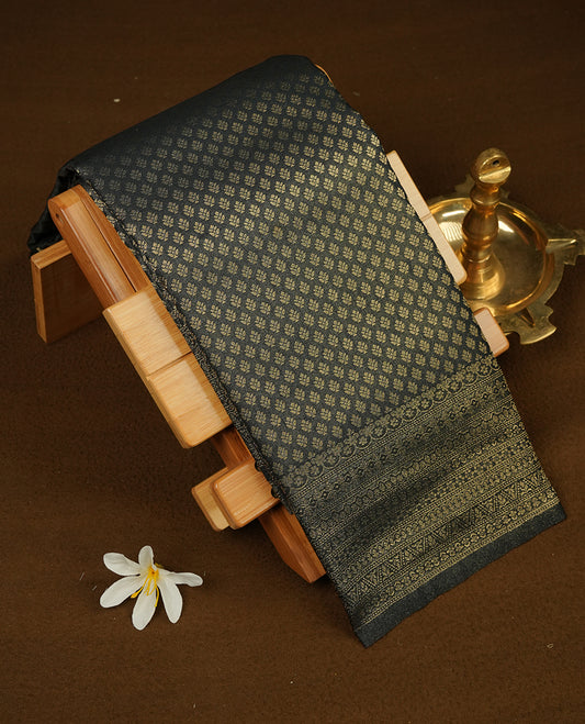 Black colour semi soft silk saree featuring gold zari motifs on across body, self colour border with traditional gold zari pattern, pallu and paired with matching blouse.