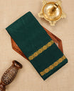 Bottle Green Colour  Sungudi Cotton Saree with gold zari motifs on the body, a matching gold zari border, and a plain pallu. Paired with a contrast Red colour  blouse piece  featuring a gold zari peacock border.