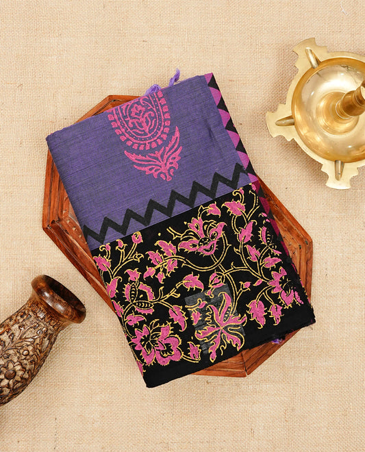 Dark Lavender Purple Chettinad Cotton Saree featuring a elegant paisley Prints on body, beautifully complemented by a contrast black floral printed border ,Paired with a matching blouse piece.