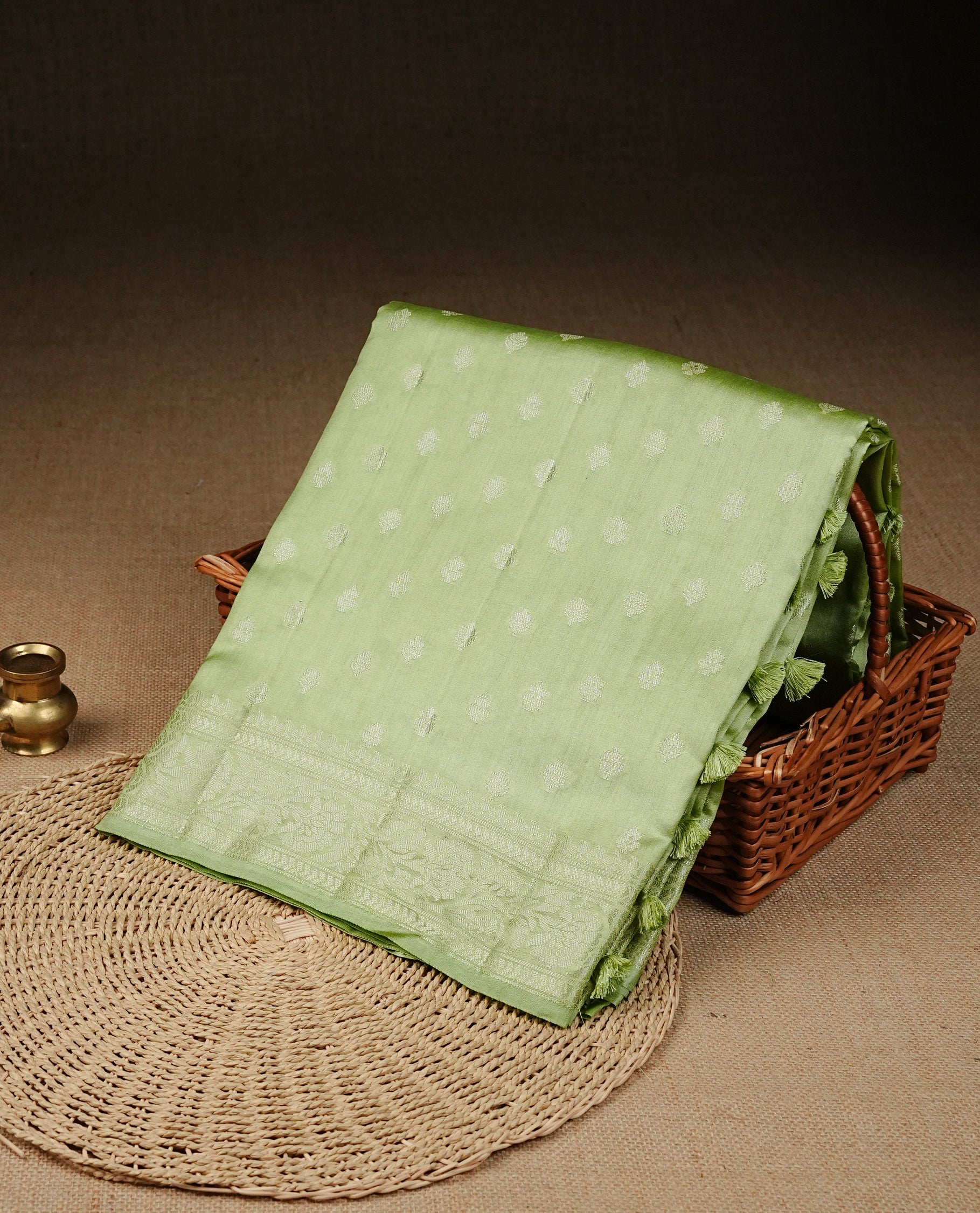 Pastel green Colour Tussar silk saree with silver zari buttas on Body , an elegant zari border and pallu, Paired With a matching blouse piece.