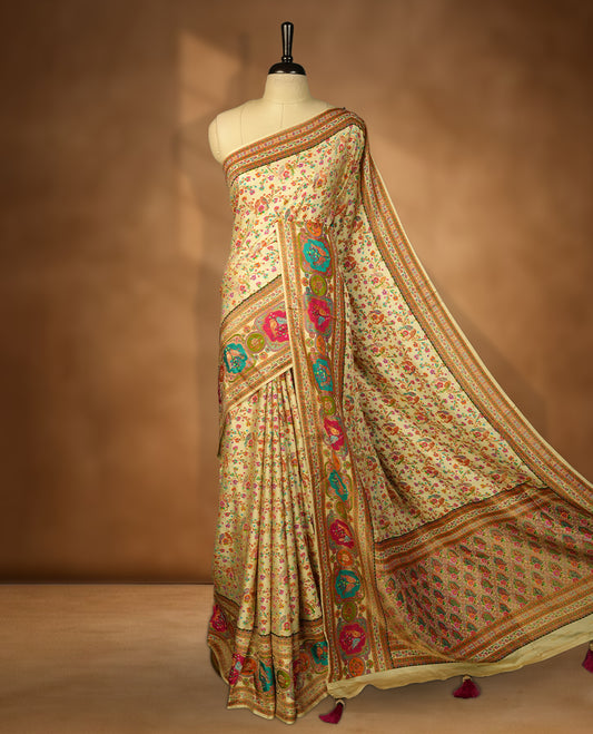 Ivory colour Pashmina silk saree densely woven with intricate multicolour floral kodi pattern across the body, framed by an opulent arabesque border and grand storytelling pallu, paired with a matching woven border blouse piece