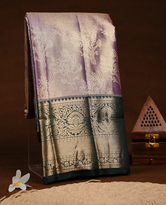 Purple & gold double shade colour semi tissue silk saree featuring gold zari tree pattern on body, contrast Green colour with gold zari traditional border, paired with matching blouse piece.