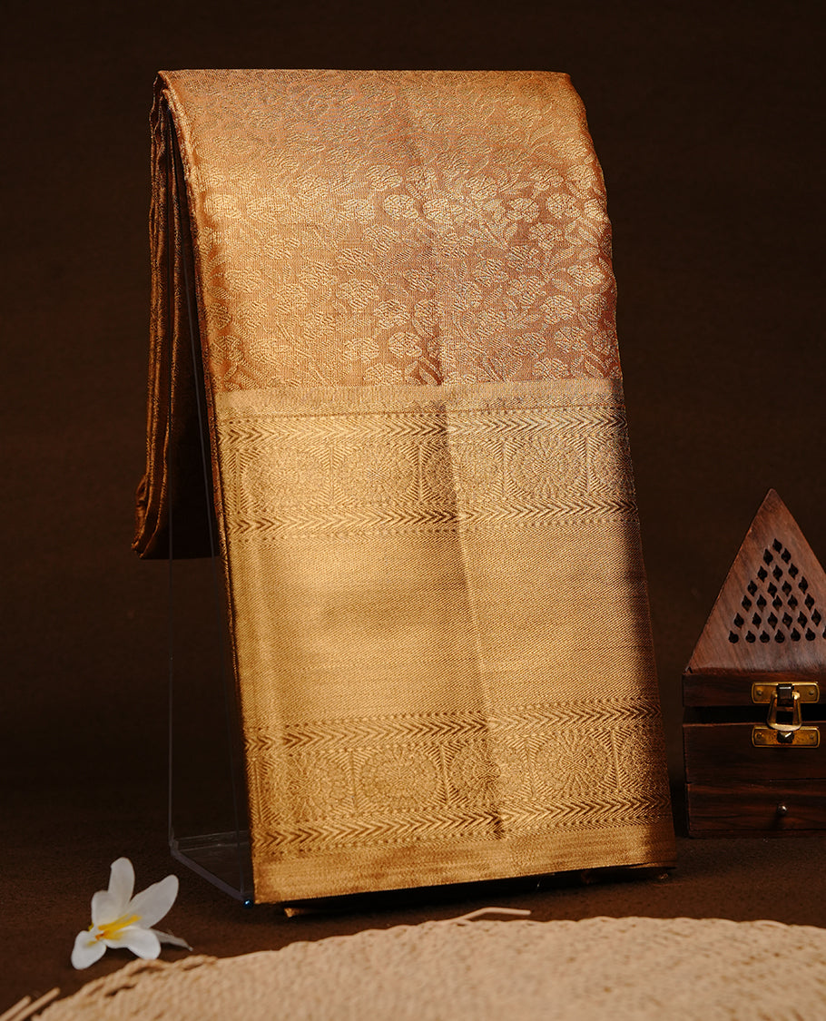 Gold colour semi tissue silk saree featuring gold zari pattern on body, self colour with gold zari traditional border, paired with matching blouse piece.