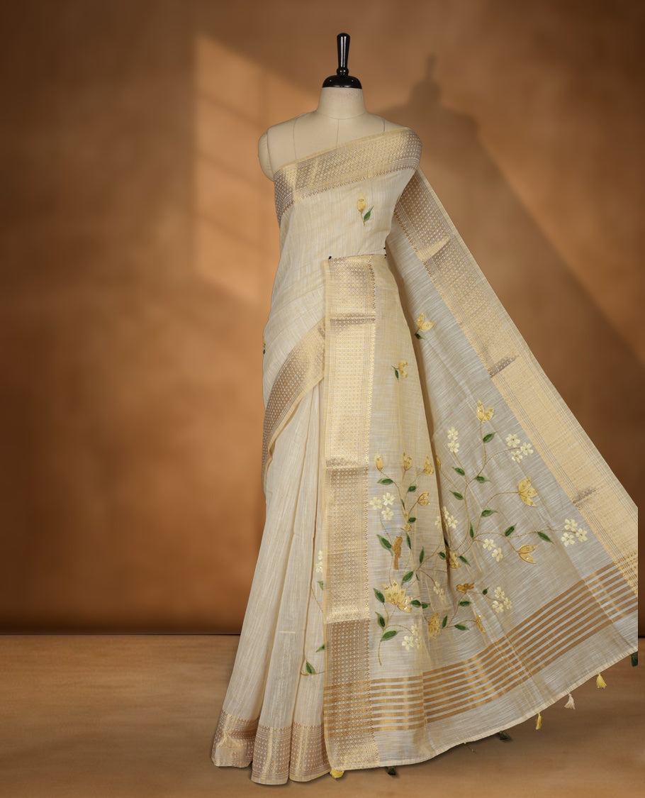 Beige colour linen silk saree featuring hand brushed colour with Floral  & birds printed pattern on body, gold zari woven geometric design border with self colour pallu and comes with a matching blouse