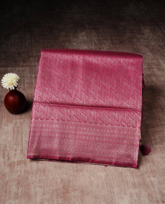 Magenta colour softie silk saree featuring silvar zari, rich pallu floral pattern brocade body, with contrasting self colour patterned border.paired with matching blouse piece.