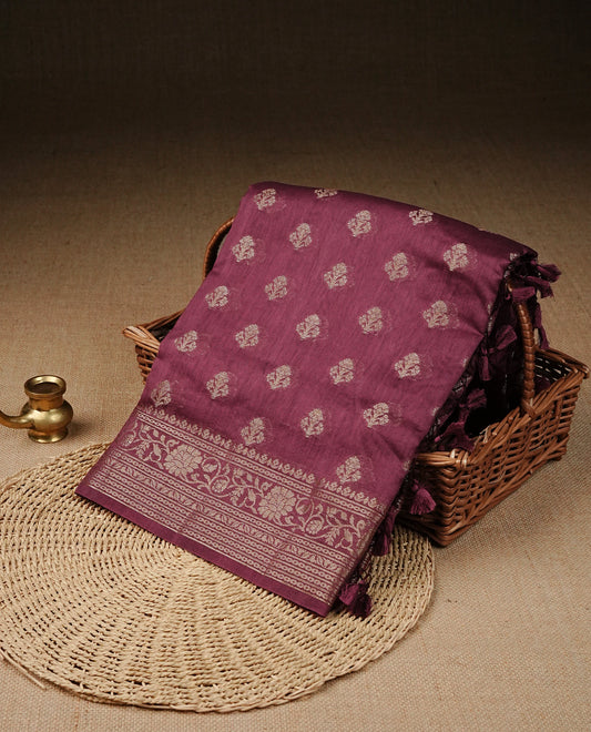 Light Maroon colour Tussar Silk saree featuring antique zari butta motifs on the body, enhanced with a self-coloured floral Kodi Gold zari border and  pallu, paired with a matching blouse piece.