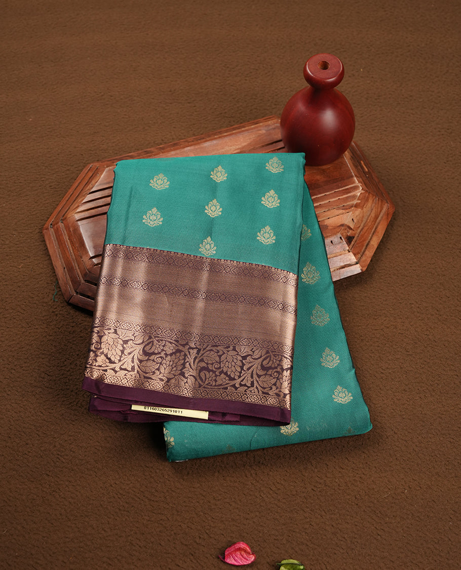 Green colour soft silk saree featuring gold zari motifs on the body, complemented by a contrast Dark purple traditional zari border and pallu, paired with matching blouse piece.