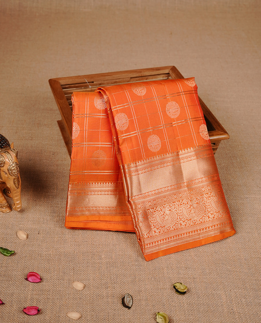 Orange colour traditional kancheepuram silk saree featuring gold zari check pattern on body, complemented by self colour with gold zari traditional border, paired with matching blouse piece.