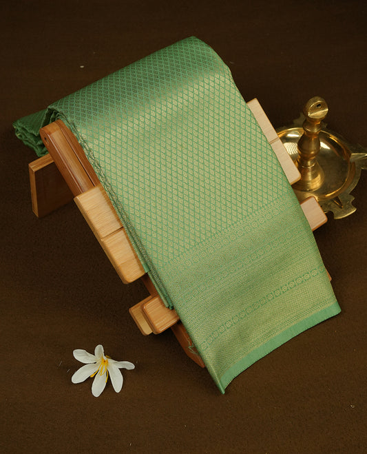 Pastel green colour semi soft silk saree featuring gold zari motifs on across body, self colour border with traditional gold zari pattern, pallu and paired with matching blouse.