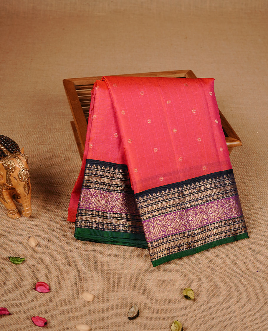 Reddish orange colour traditional kancheepuram silk saree featuring gold zari check pattern on body, complemented by contrast multicolour with gold zari traditional border, paired with matching blouse piece.
