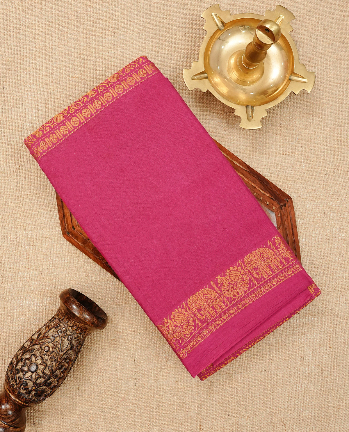 Magenta  Colour Sungudi Cotton Saree with gold zari elephant & Peacock motifs on the body, a self zari border, and a rich gold zari pallu. Paired with a Contrast Navy Blue colour blouse Piece featuring a gold zari border.