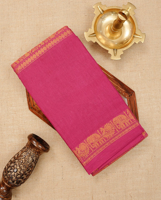 Magenta  Colour Sungudi Cotton Saree with gold zari elephant & Peacock motifs on the body, a self zari border, and a rich gold zari pallu. Paired with a Contrast Navy Blue colour blouse Piece featuring a gold zari border.