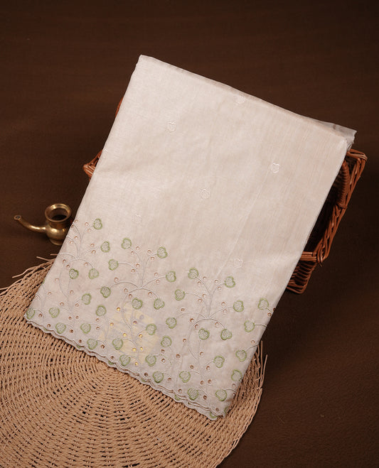 Beige colour Tussar silk saree featuring Elegant plain body, highlighting Green colour thread floral kodi worked scalp border, pallu and paired with matching blouse piece.