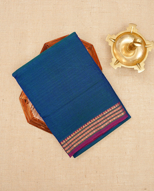 Teal Blue colour Narayanapattu cotton saree with a plain body, complemented by a magenta colour with Gold Zari border & contrast pallu, paired with a matching blouse piece.