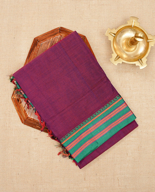 Dark magenta colour Narayanapattu cotton saree with a plain body, complemented by a green colour with gold zari border & contrast pallu, paired with a matching blouse piece.