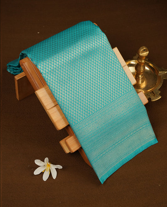 Aqua blue colour semi soft silk saree featuring gold zari motifs on across body, self colour border with traditional gold zari pattern, pallu and paired with matching blouse.