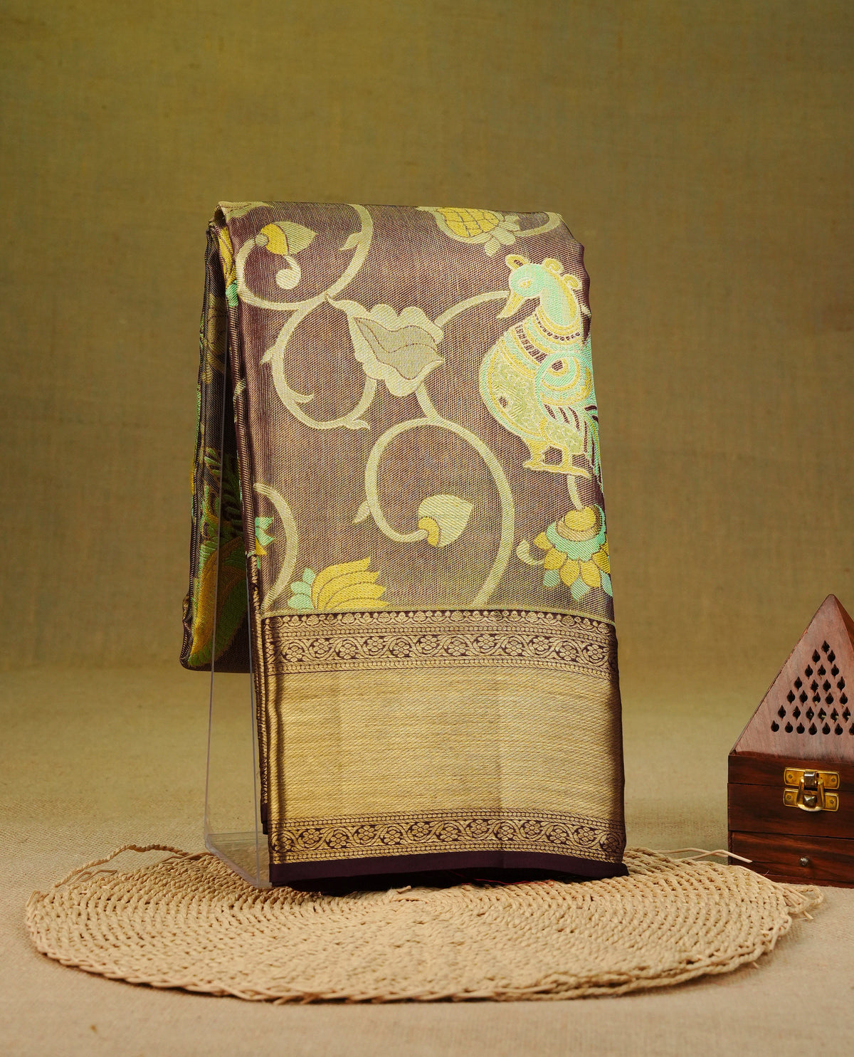 Chocolate & gold double shade pure tissue silk saree featuring aqua zari floral kodi pattern with peacocak on body, complemented by self colour with traditional border, comes with matching blouse piece.