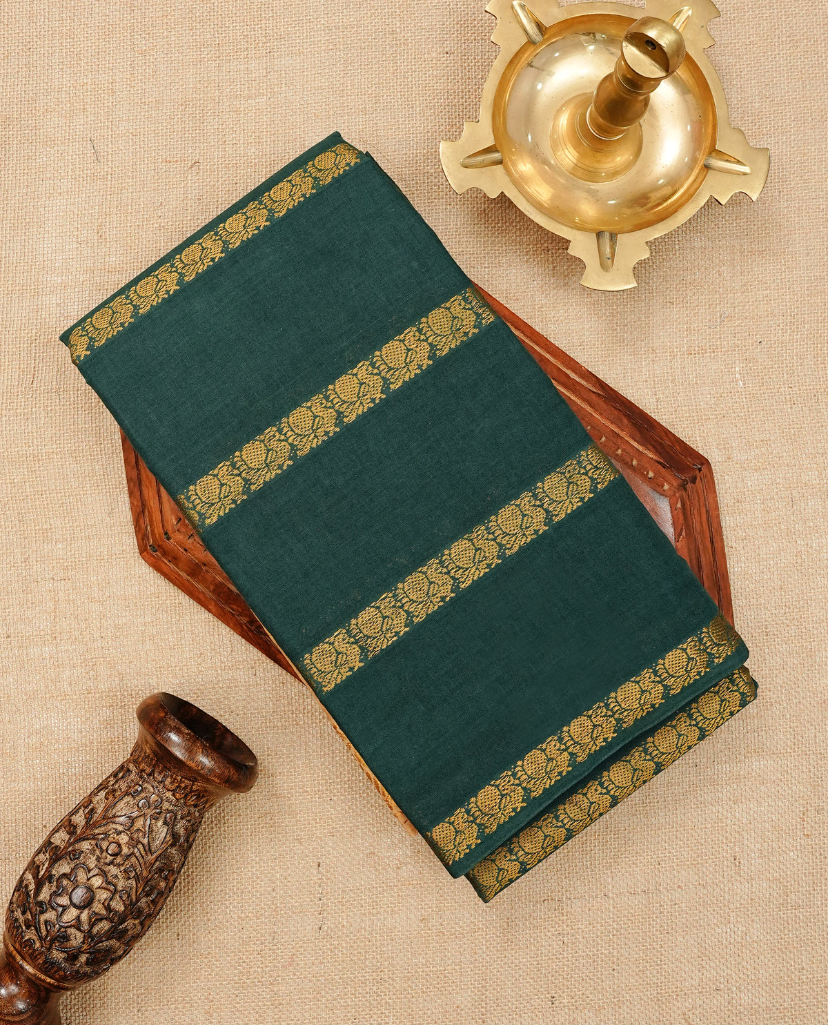 Bottle Green Colour Sungudi Cotton Saree with peacock gold zari stripes on the body, a matching gold zari border, and a striped gold zari pallu. Paired with a contrast Beige blouse piece  featuring gold zari work.