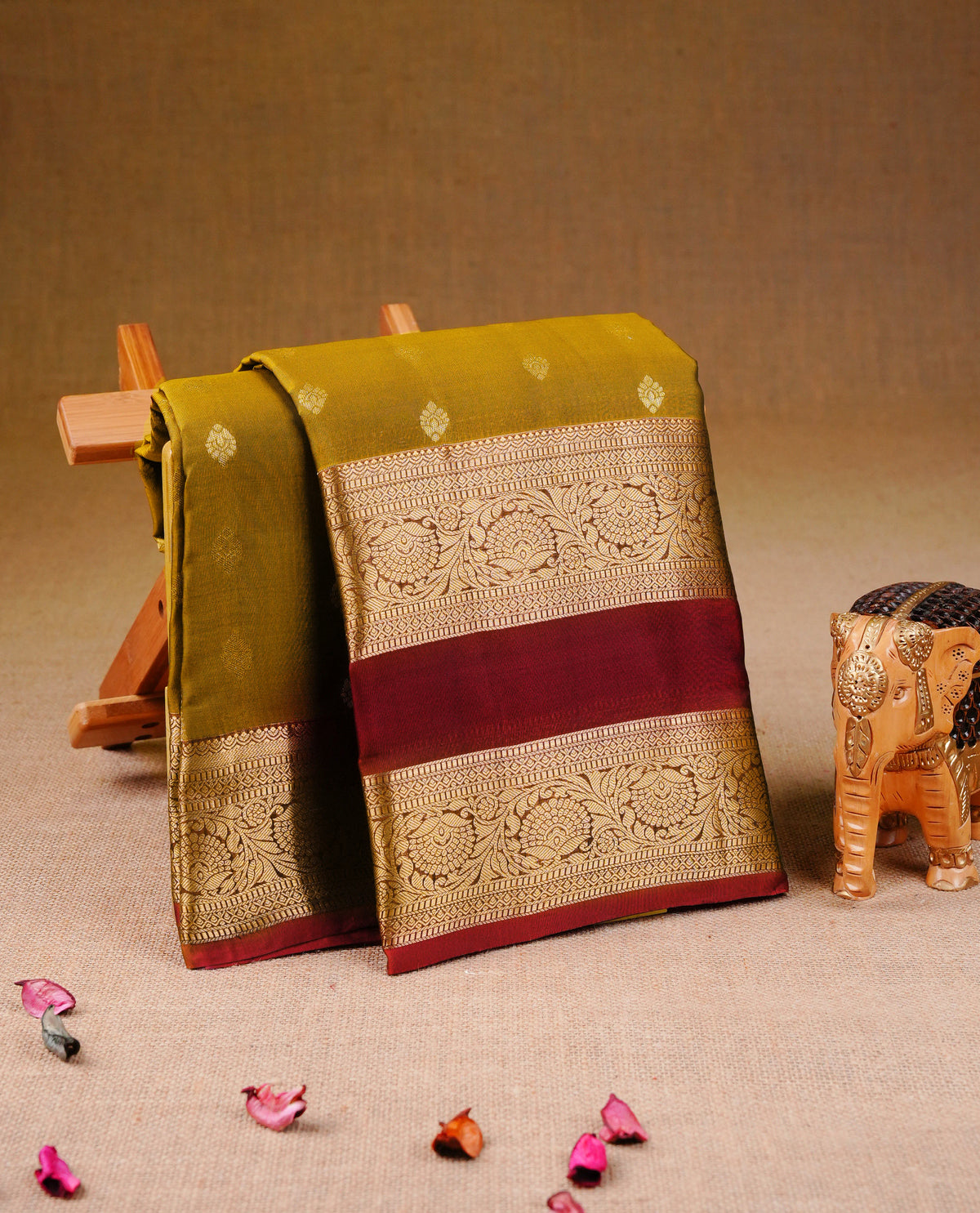 Mustard olive colour Traditional Kancheepuram Silk Saree with Elegant Gold Zari Buttas on the Body, Enhanced with a Contrast Dark red Colour  with Gold Zari Border and Rich Pallu, Paired with a Matching Blouse Piece.