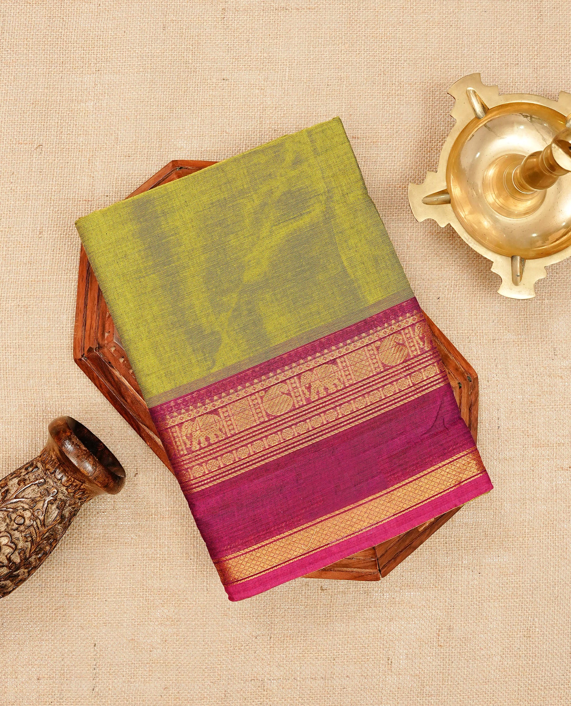 Olive green colour chettinad cotton saree featuring elegant plain body, Contrast magenta colour with Gold zari border, comes with matching blouse piece.