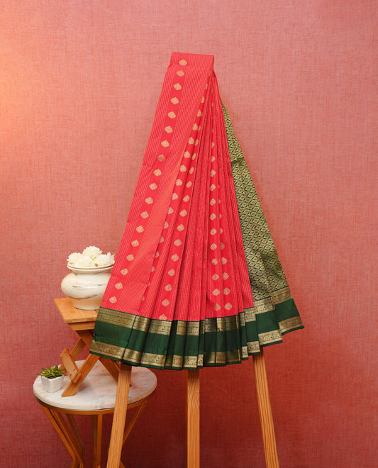 Red colour soft silk saree featuring gold zari stripes with floral motifs on body, contrast dark green colour gold zari elephant & peacock traditional border, grand pallu comes with matching blouse piece.