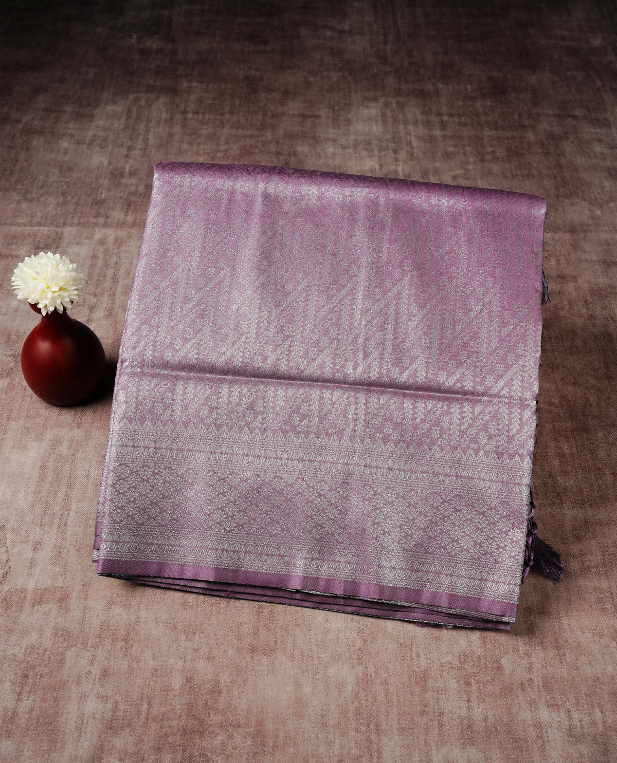 Lavender colour softie silk saree featuring silver zari, rich pallu floral pattern brocade body, with contrasting self colour colour border.paired with matching blouse piece.