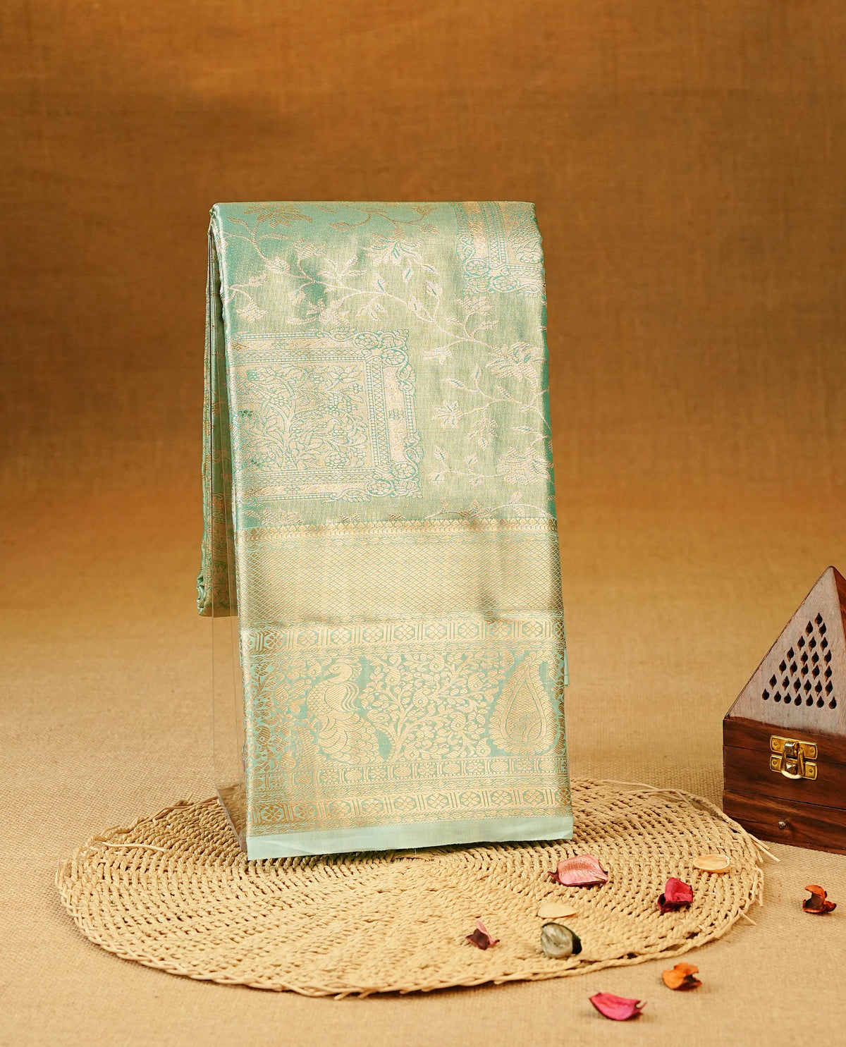 Aqua Blue colour Semi Tissue Silk Saree featuring gold zari floral kodi Works on the body, complemented by an intricately woven gold zari pallu, a rich self-coloured border with gold zari work, and paired with a matching plain blouse piece.