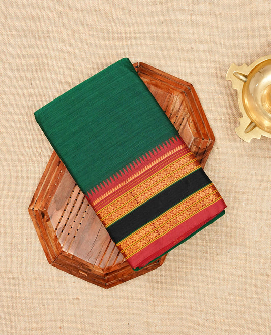 Bottle Green colour Narayanapattu cotton saree with a plain body, complemented by a maroon colour with gold zari border & contrast pallu, paired with a matching blouse piece.
