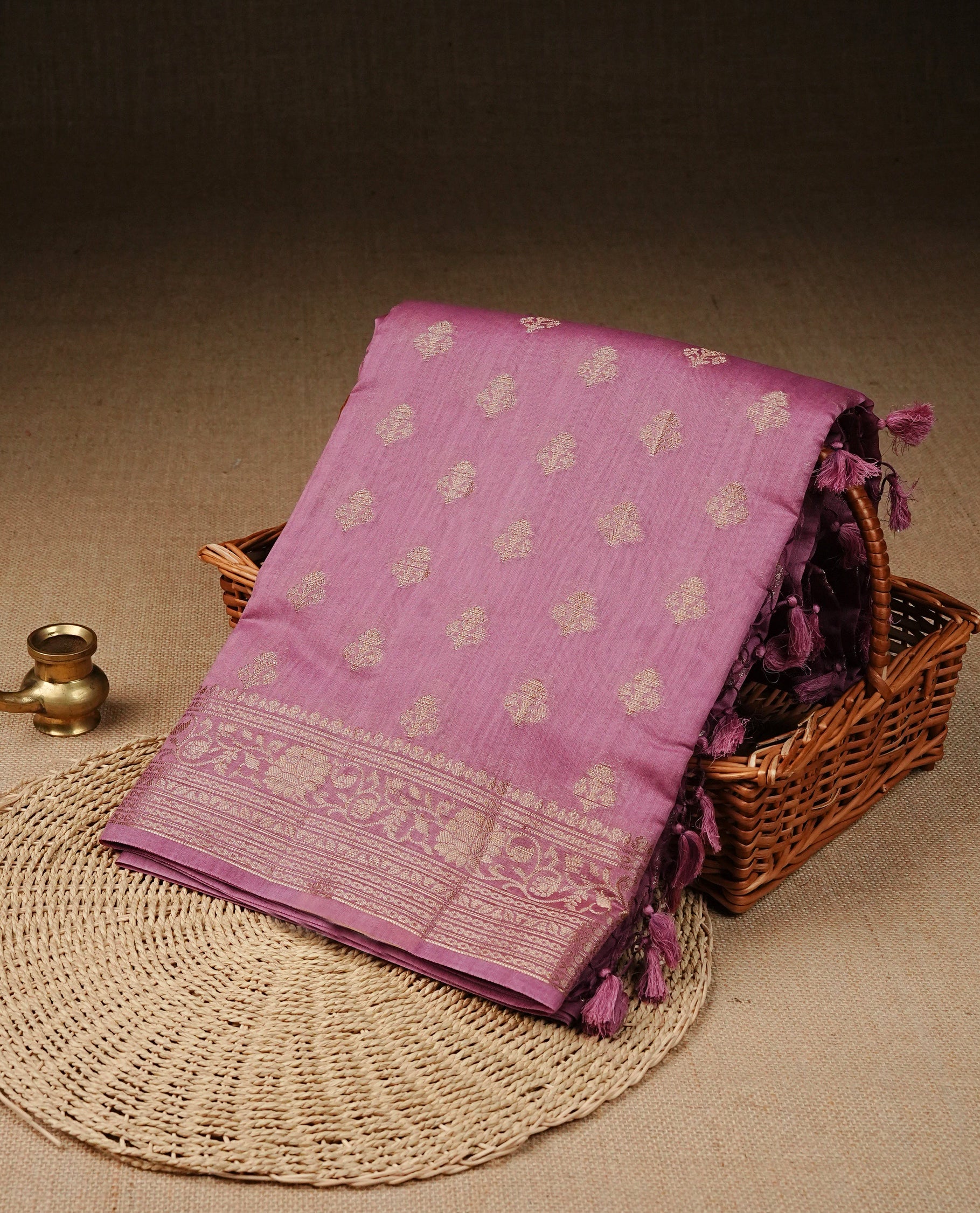 Onion Pink colour Tussar Silk saree featuring antique zari butta motifs on Body , enhanced with a self coloured floral Gold zari border and pallu, paired with a matching blouse piece.