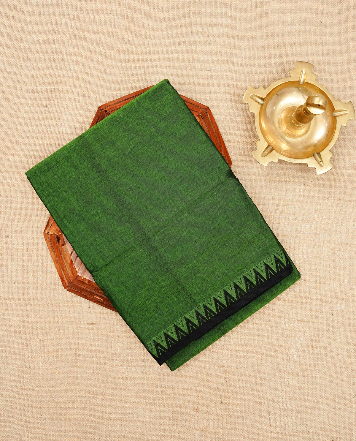 Green colour Narayanapattu cotton saree with a plain body, complemented by a Black colour with Black temple designed border & contrast pallu, paired with a matching blouse piece.