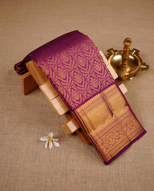 Purple colour kancheepuram silk saree featuring gold zari pattern across body, complemented by selfcolour border traditional zari border, paired with matching blouse piece.