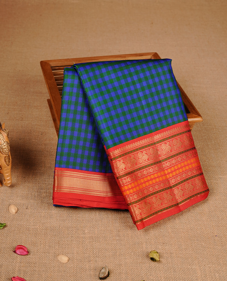 Indigo & green  colour traditional kancheepuram silk saree featuring gold zari check pattern on body, complemented by contrast red colour with gold zari traditional border, paired with matching blouse piece.