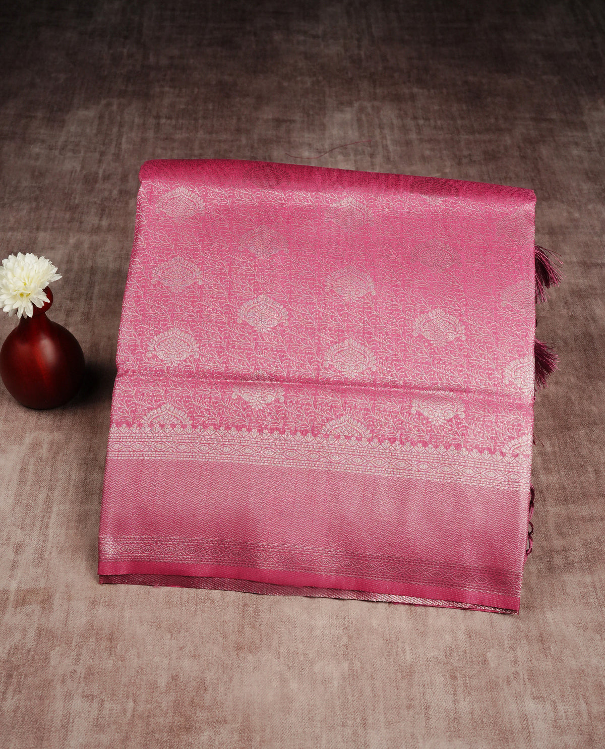 Magenta colour softie silk saree featuring silver zari, rich pallu floral brocade body, with contrasting self colour border.paired with matching blouse piece.
