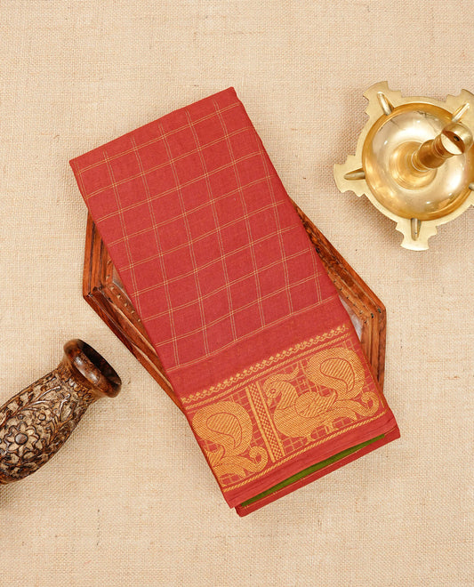 Red Sungudi cotton saree featuring elegant gold zari checks across the body, complemented by a rich gold zari peacock border. Paired with a matching blouse piece