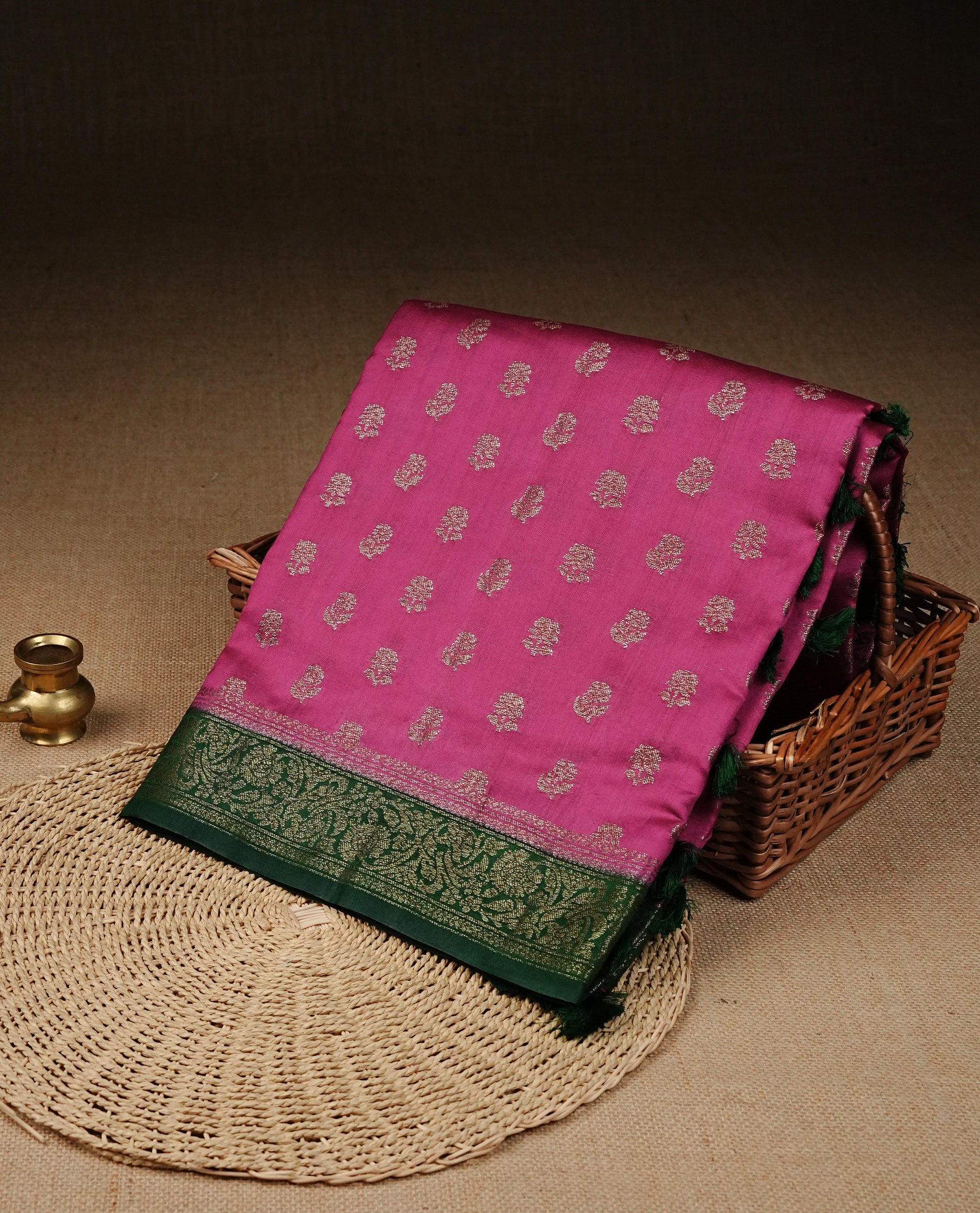 Vibrant pink Colour Tussar silk saree with antique zari buttas On Body, a rich green zari border, an elegant pallu, Paired With  a matching blouse piece.